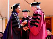 Rice makes an appearance at Boston College, where she is greeted by Father William Leahy.