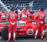 Prominent Marlboro branding on Ferrari F1 car and team at the Bahrain Grand Prix 2006.