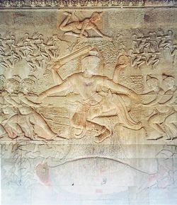 The bas-relief of the Churning of the Sea of Milk shows Vishnu in the centre, his turtle avatar Kurma below, asuras and devas to left and right, and apsaras and Indra above.