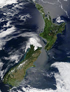 New Zealand from space. The snow-capped Southern Alps dominate the South Island, while the North Island's Northland Peninsula stretches towards the subtropics