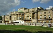 The west facade of Buckingham Palace seen from the Palace Gardens.