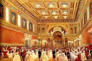 The State Ballroom is the largest room at Buckingham Palace. It was added by Queen Victoria and is used for ceremonies such as investitures and state banquets. This picture dates from 1856. The polychrome colour scheme has been replaced by mainly white decoration with gold details and red upholstery.