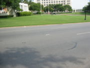 Looking south, with the pergola and knoll behind the photographer: the X on the street marks the position of the final head shot (photo taken in July 2006)