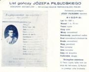 1928 reproduction of an 1887 Tsarist Russian wanted poster for Piłsudski, distributed (presumably by his political enemies) "on the 10th anniversary of Poland's independence": Translation   "State criminal JÓZEF PIŁSUDSKI, nobleman DESCRIPTION: Age 19 (1887) Height 1 meter, 75 cm. Face clear Eyes grey Hair dark-blond Sideburns light-blond, sparse Eyebrows dark-blond, fused Beard dark-blond Mustache light-blond Nose normal Mouth normal Teeth missing some Chin round Distinctive marks: 1) clear face, with eyebrows fused over nose, 2) wart at the end of right ear"