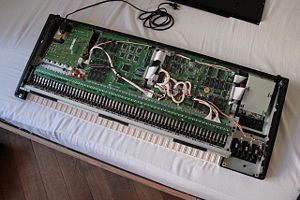 The inside of a Yamaha SY77 synthesizer shows the various internal components.