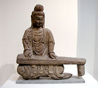 Rock carving of a bodhisattva playing a guqin, found in Shanxi, Northern Wei Dynasty (386–534).