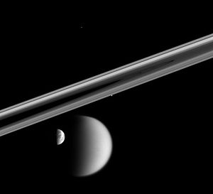 Four of Saturn's moons: Dione, Titan, Prometheus (edge of rings), Telesto (top center)