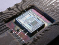 The integrated circuit from an Intel 8742, an 8-bit microcontroller that includes a CPU running at 12 MHz, 128 bytes of RAM, 2048 bytes of EPROM, and I/O in the same chip.