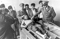 His corpse was displayed to the World press in the laundry house of the Vallegrande hospital.      Side angle    From above     Face