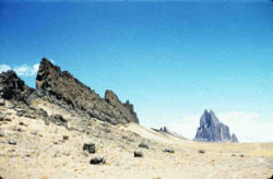 Shiprock, New Mexico, United States: a volcanic neck in the distance, with radiating dike on its south side. Photo credit: USGS Digital Data Series