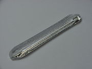 A synthetic quartz crystal grown by the hydrothermal method, about 19 cm long and weights about 127 grams