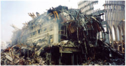The outer shell of the south tower (tower 2) of the WTC is still standing at right. The 22 story Marriott Hotel in the foreground was crushed when the adjacent tower collapsed.