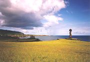 Two ahu at Hanga Roa. In foreground Ahu Ko Te Riku (with a Pukao on its head). In the mid-ground is a side view of an Ahu with five moai showing retaining wall, platform, ramp and pavement.