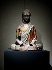 A Chinese Tang Dynasty (618–907) sculpture of the Buddha seated in meditation.