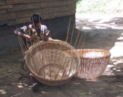 A woman weaves a basket near Lake Ossa, Littoral Province. Cameroonians practice such handicrafts throughout the country.