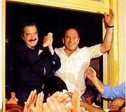 Raul Alfonsin (left) greets supporters during the 1983 campaign with his trademark salute.