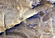 Tectonic fractures within the Candor Chasma region of Valles Marineris, Mars, retain ridge-like shapes as the surrounding bedrock erodes away. This points to past episodes of fluid alteration along the fractures and reveals clues into past fluid flow and geochemical conditions below the surface.
