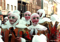 The Gilles of Binche, in costume, wearing wax masks