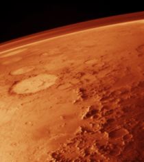 Mars's thin atmosphere, visible on the horizon in this low-orbit photo.