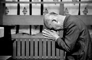 A man praying at a Shinto shrine