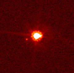 Eris (centre) and Dysnomia (left of centre), taken by the Hubble Space Telescope.