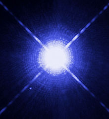 The image of Sirius A and Sirius B taken by Hubble Space Telescope. The white dwarf can be seen to the lower left. The diffraction spikes and concentric rings are instrumental effects.