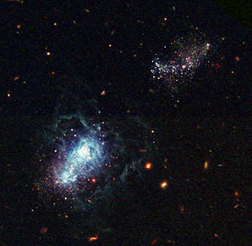 I Zwicky 18 (lower left) resembles a newly-formed galaxy.. Credit:Hubble Space Telescope/NASA/ESA.