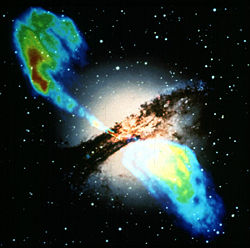 A radio map of the galaxy Centaurus A (upper left and lower right) is overlaid across the optical image (center), showing two lobes from the jets being generated by an active nucleus.  Credit:NASA.