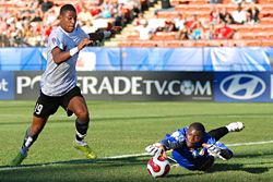 Austrian forward Rubin Okotie tries to shoot past Congo goalkeeper Destin Onka at the 2007 FIFA U-20 World Cup. Onka makes the save. (shot at Commonwealth Stadium in Edmonton, Alberta, Canada)