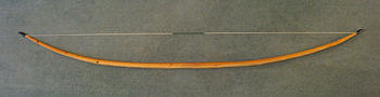 Self-yew English longbow, 6 ft 6 in long, 105 lbf draw force.
