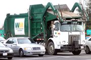 A typical front loading garbage truck in North America.