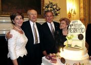 Ford at his 90th birthday party with Laura Bush, President George W. Bush, and Betty Ford in the White House State Dining Room in 2003.