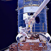 Astronauts installing corrective optics during SM1