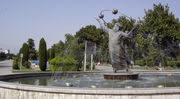 Laleh Park's southwestern entrance with a statue of Biruni, a medieval Persian astronomer. Tehran, Iran.