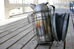 Bee smoker with heat shield and hook