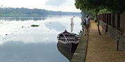 In the Backwaters, waterways are key thoroughfares for merchants selling fish, rice, and other products. Pictured is a waterway bordering a farm.