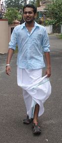 A Malayali man wearing a mundu and a shirt.