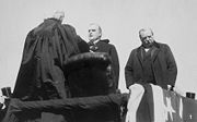 Chief Justice Melville Fuller administering the oath to McKinley as president in 1897. Out-going president, Grover Cleveland, stands to the right.