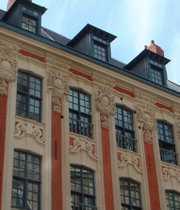 The black dots around the windows  (not the decorative cartouches) are Austrian cannonballs lodged in the façade.