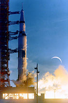 Apollo 8 during launch, with a double exposure of the Moon, which was not visible during launch (NASA)