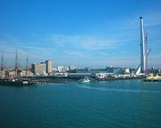 Portsmouth harbour, with HMS Warrior on the left, Portsmouth Harbour railway station in the centre, and construction of the Spinnaker Tower on the right.