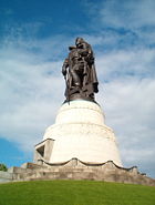 The Soviet War Memorial in Treptower Park in Berlin. The statue depicts a Soviet soldier cradling a German child, while standing on a broken Swastika.