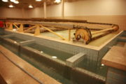 Mechanical system to push floc out of the water basin