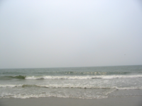 The Atlantic Ocean as seen from the eastern coast of North America near the shared boundary of North and South Carolina on a hazy summer day.