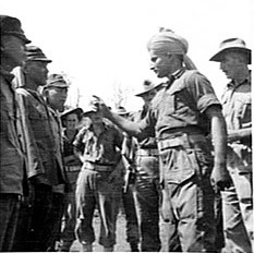 November 9, 1945. Jemadar (junior commissioned officer) Chint Singh of the Indian Army at an identification parade in New Guinea, indicating a Japanese soldier whom he claimed mistreated him while he was a prisoner of war. Japanese forces used many Indian Army personnel captured in Malaya and Singapore as forced labour in the South West Pacific.