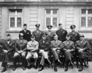 Eisenhower (seated, middle) with other US Army officers, 1945. From left to right, the front row includes Simpson, Patton, Spaatz, Eisenhower, Bradley, Hodges, and Gerow.