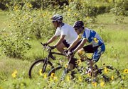 George W. Bush and Armstrong mountain biking at Prairie Chapel Ranch