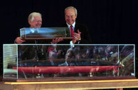 President Carter holding up a model of the submarine that will carry his name
