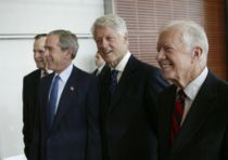 President Carter (right), walks with, from left, former President George H.W. Bush, George W. Bush and William Jefferson Clinton during the dedication of the William J. Clinton Presidential Center and Park in Little Rock, Arkansas, November 18, 2004