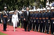 President Bush inspects the Malacanang Palace honor guards with Philippines' President Gloria Arroyo during the former's state visit in Manila on October 2003.